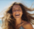 A woman feeling vibrant and energized, exuding happiness and wellness. Achieve a balanced and fulfilling life with comprehensive wellness practices.