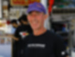 Man smiling in a purple cap and "RUN FOR FREEDOM" t-shirt